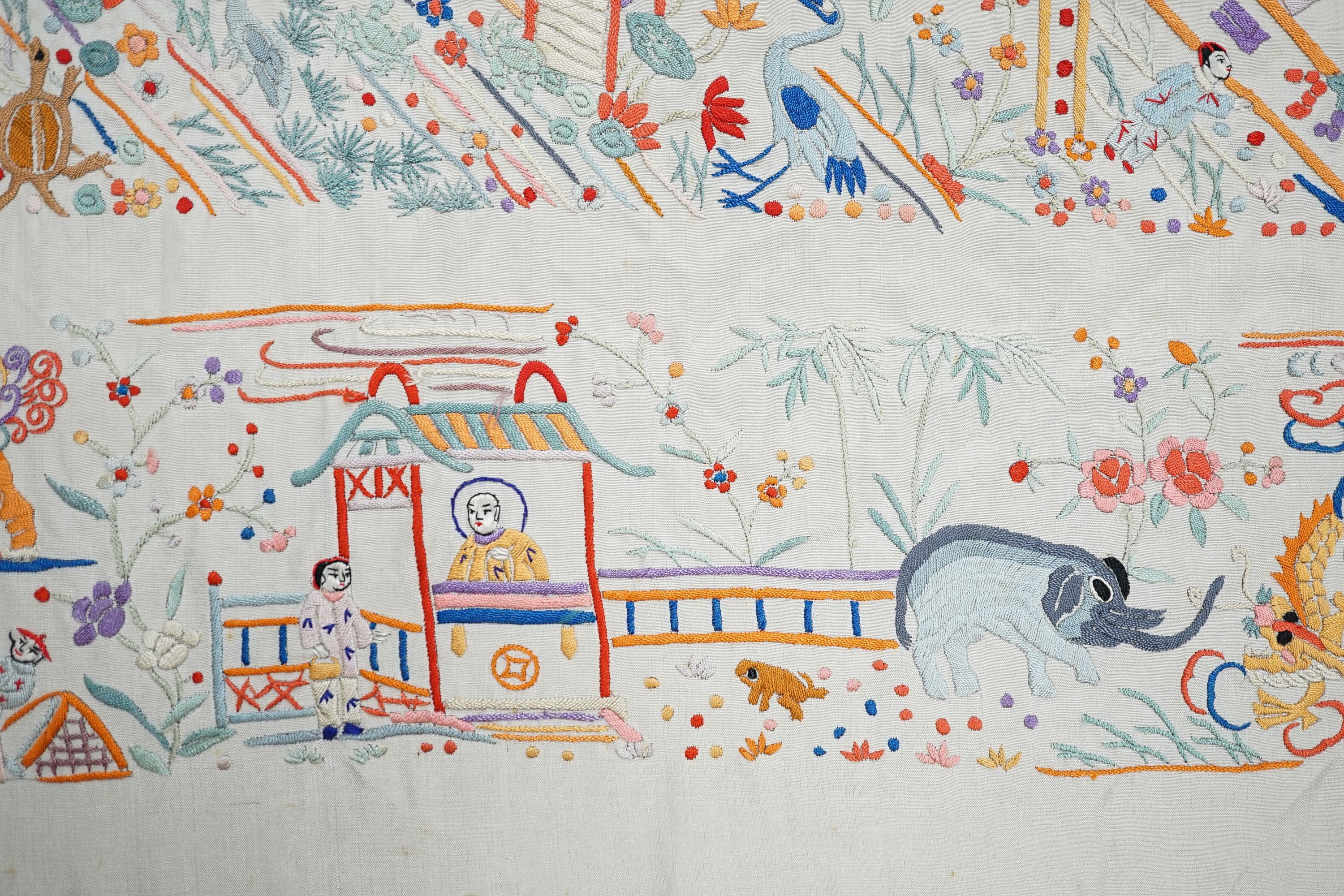 A Chinese cream silk shawl with fine multi coloured all over embroidery depicting figurative scenes and animals